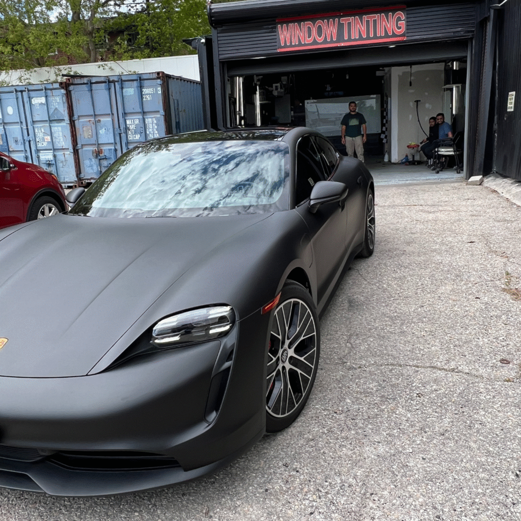 Black sport car with full-body wrap and tint windows