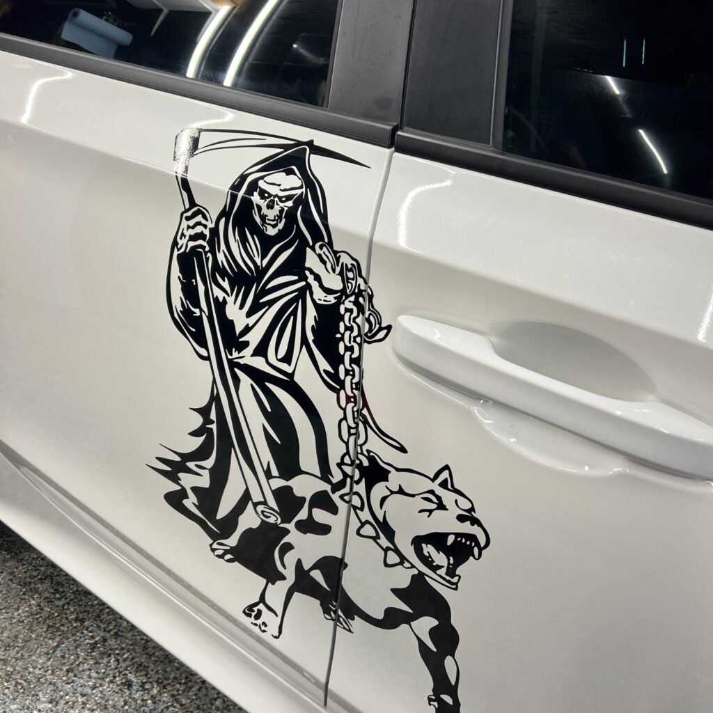 Grim Reaper and dog decal on car door